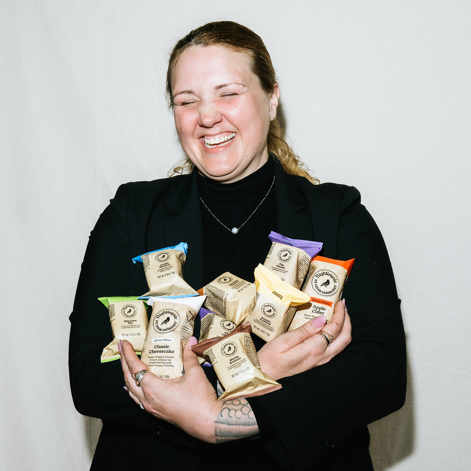 lady holding many ice cream sandwiches