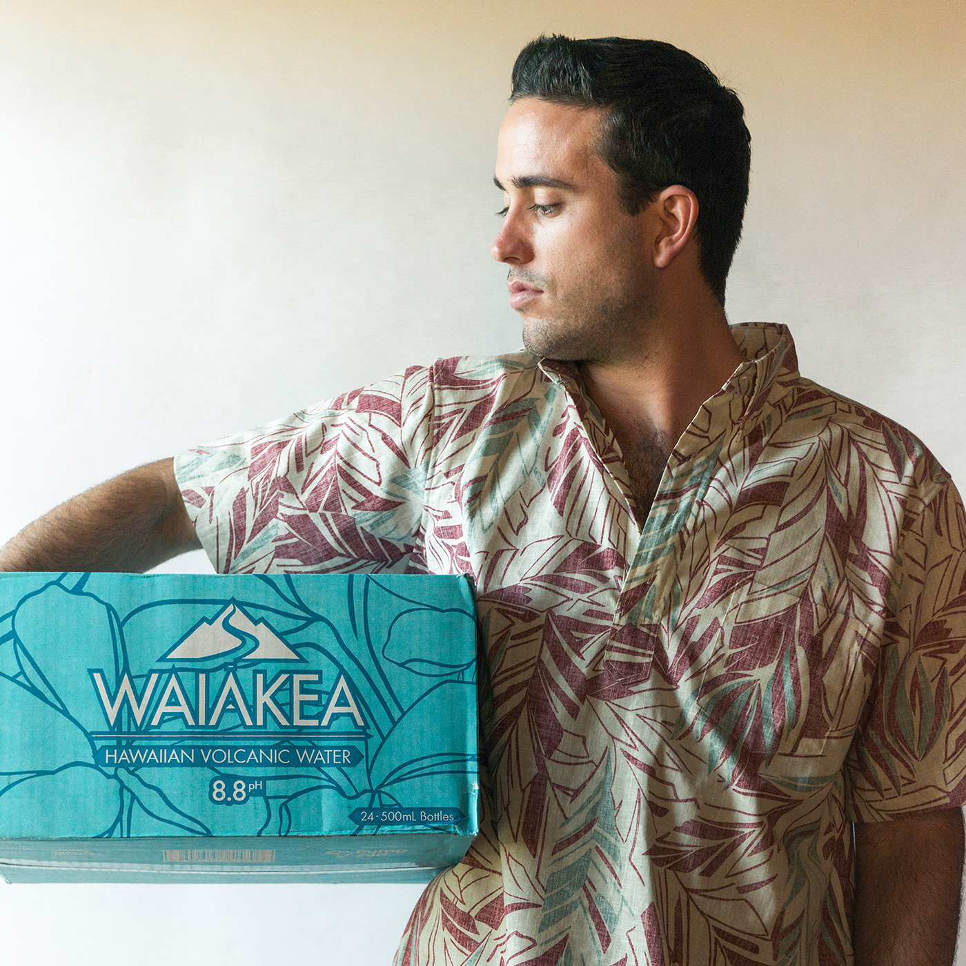 man holding case of WAIĀKEA