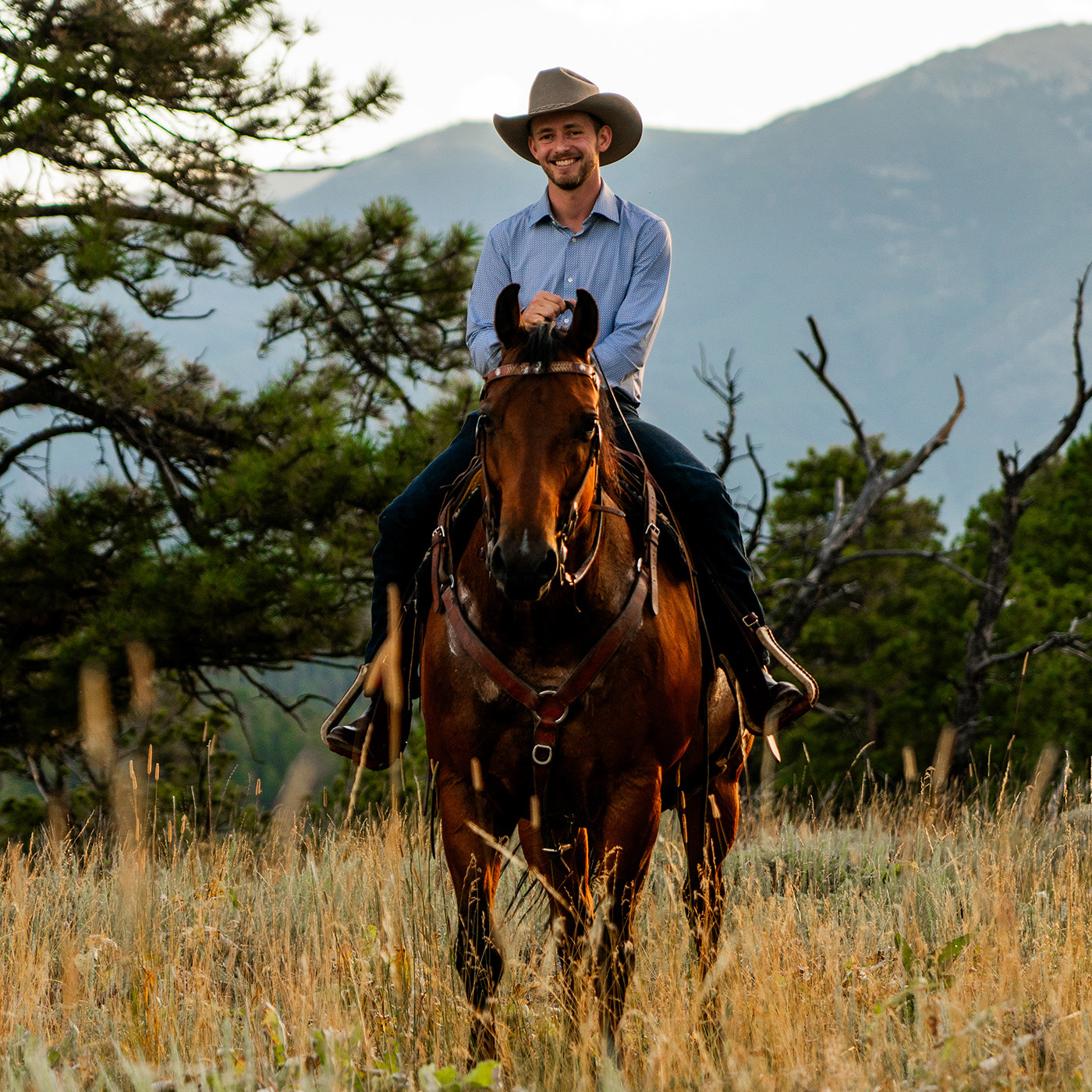 Man on horse posing for picture